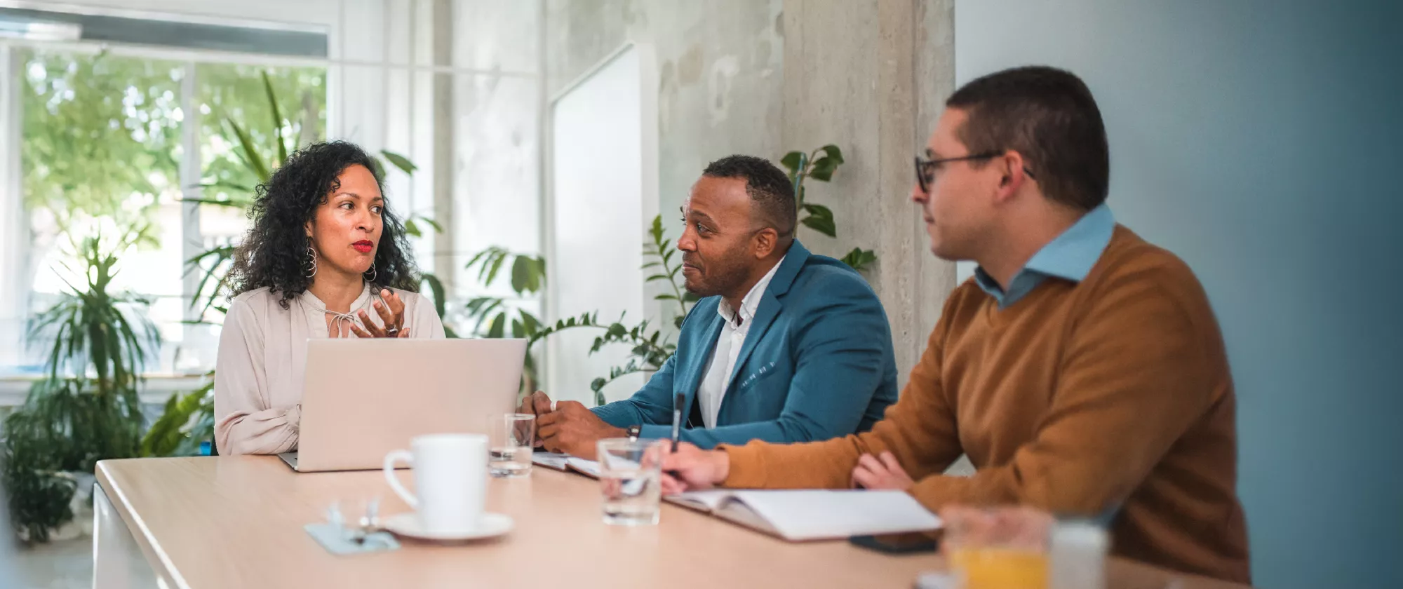 A picture shows three professional people, negotiating in an office space, reflecting the ILO’s tripartite constituents.  