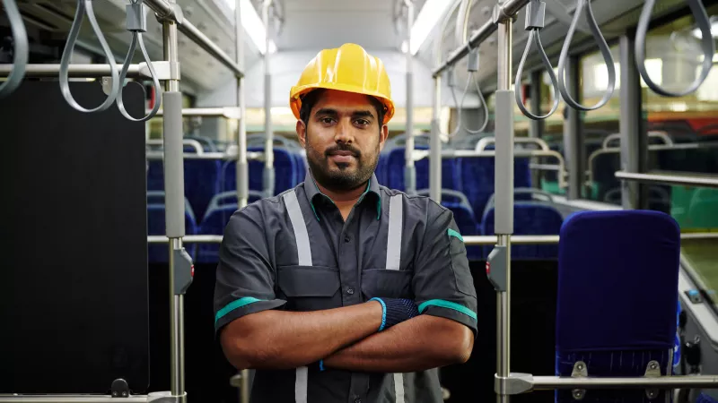 Male construction worker in a bus