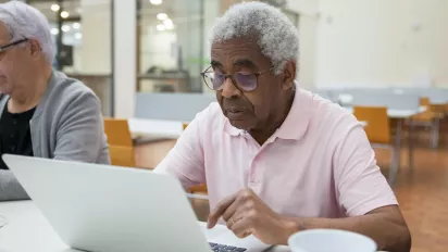 old man using laptop