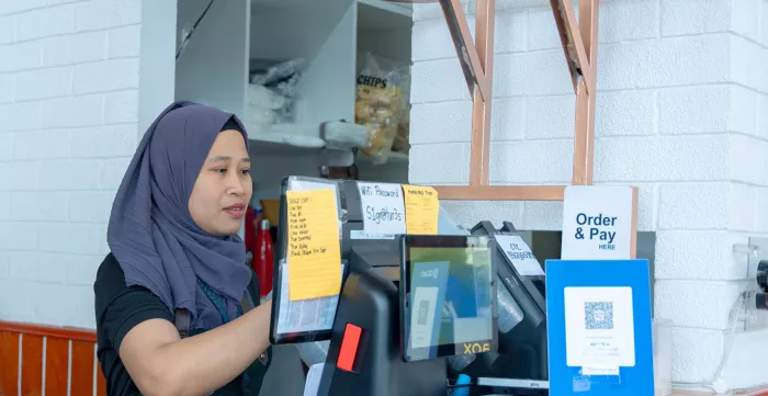 a cashier accepts digital payment using a QR code