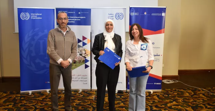 woman government official and ILO staff standing