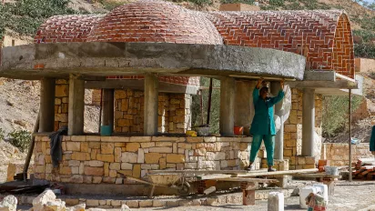 Men working on a traditional stone structure