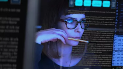 Researcher looking at data on a screen